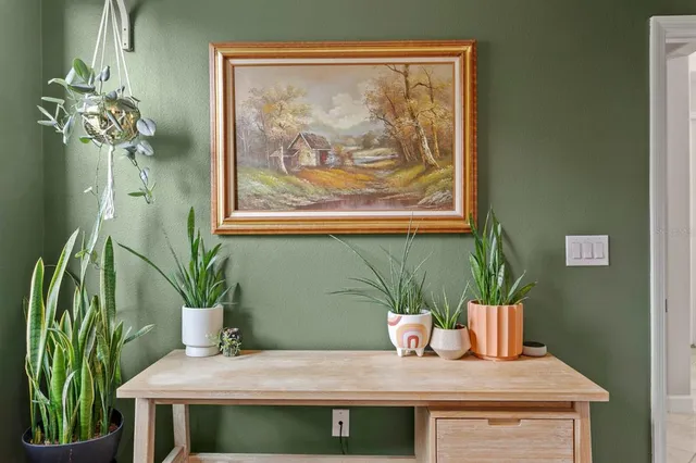 a table with a vase and flowers on it