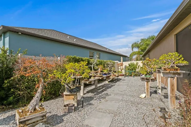 a backyard of a house with chairs