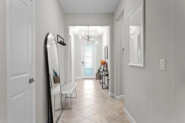a view of a hallway with windows and closet
