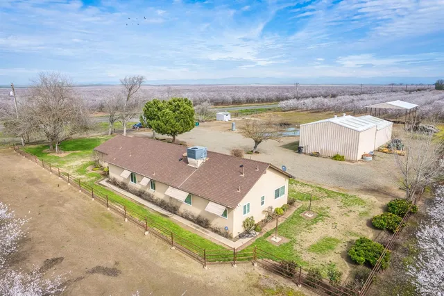 an aerial view of a house with a yard