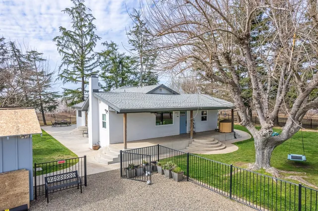an aerial view of a house with yard swimming pool and outdoor seating