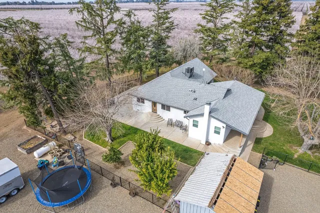 an aerial view of a house with garden space and sitting area