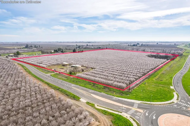 a view of a tennis ground with a wooden fence