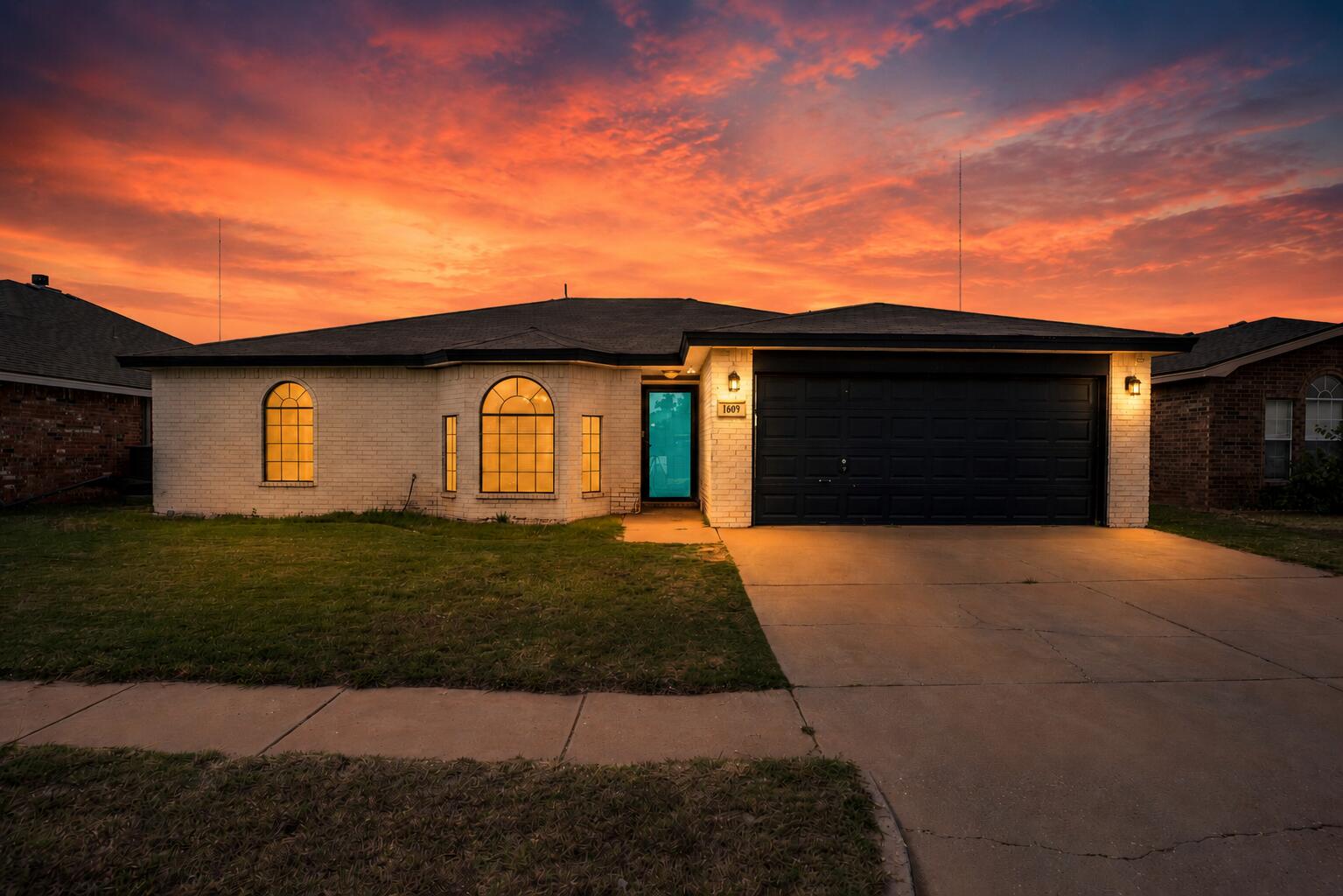 1609 78th Street Lubbock, TX 79423 - Photo 1 of 36 a front view of a house with a garden