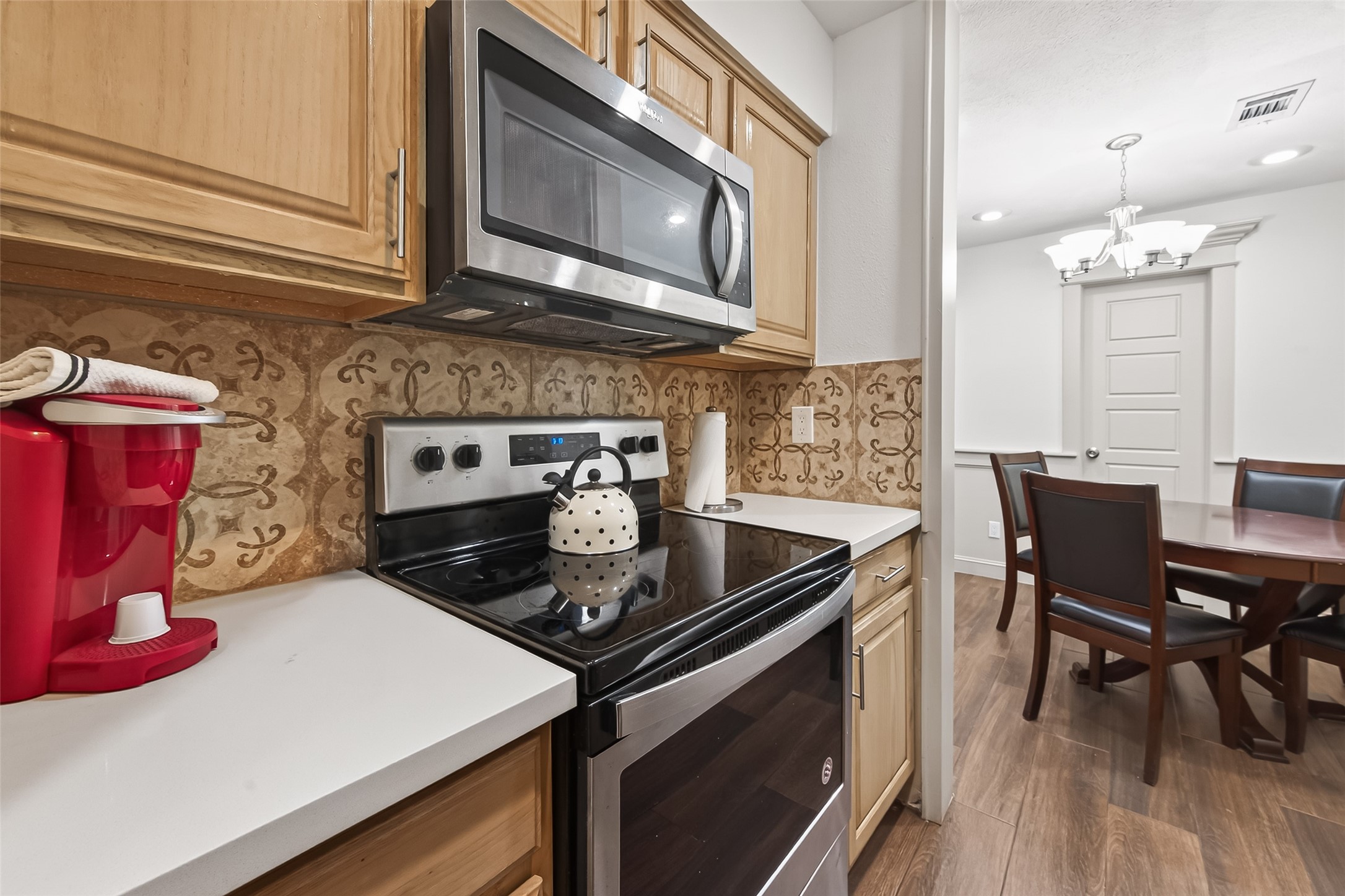 3684 Ocee Street Houston, TX 77063 - Photo 11 of 32 a kitchen with stainless steel appliances granite countertop a stove and a microwave