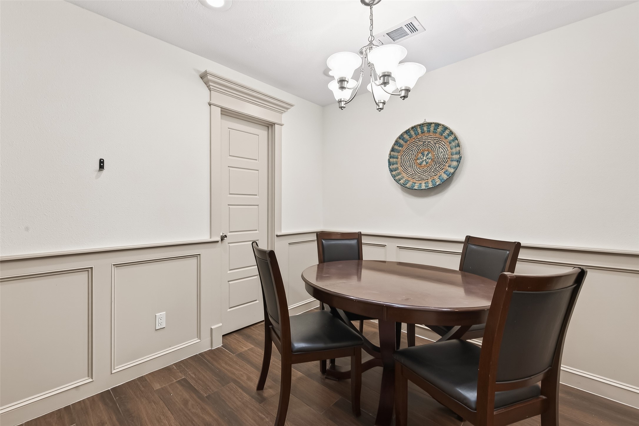 3684 Ocee Street Houston, TX 77063 - Photo 8 of 32 a view of a dining room with furniture wooden floor and a chandelier
