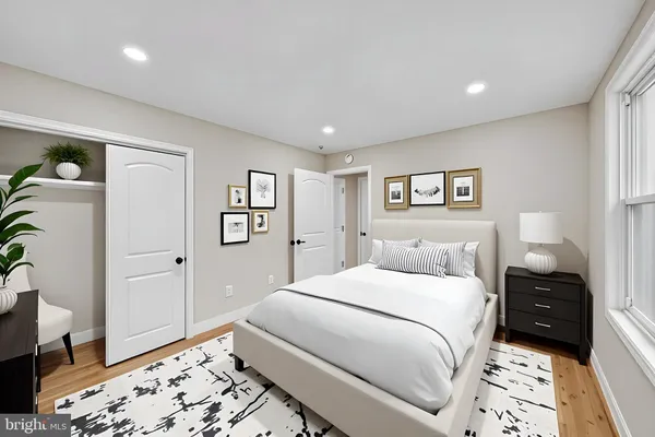a bedroom with a bed couch and window