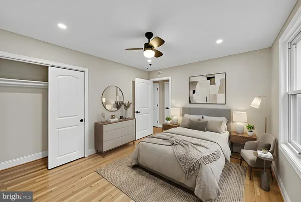a bedroom with a large bed and a large window