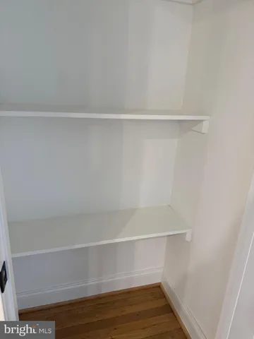 a room with wooden floor and windows