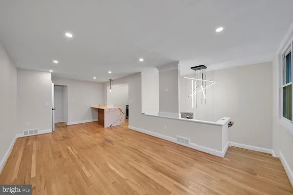 a view of an empty room with wooden floor