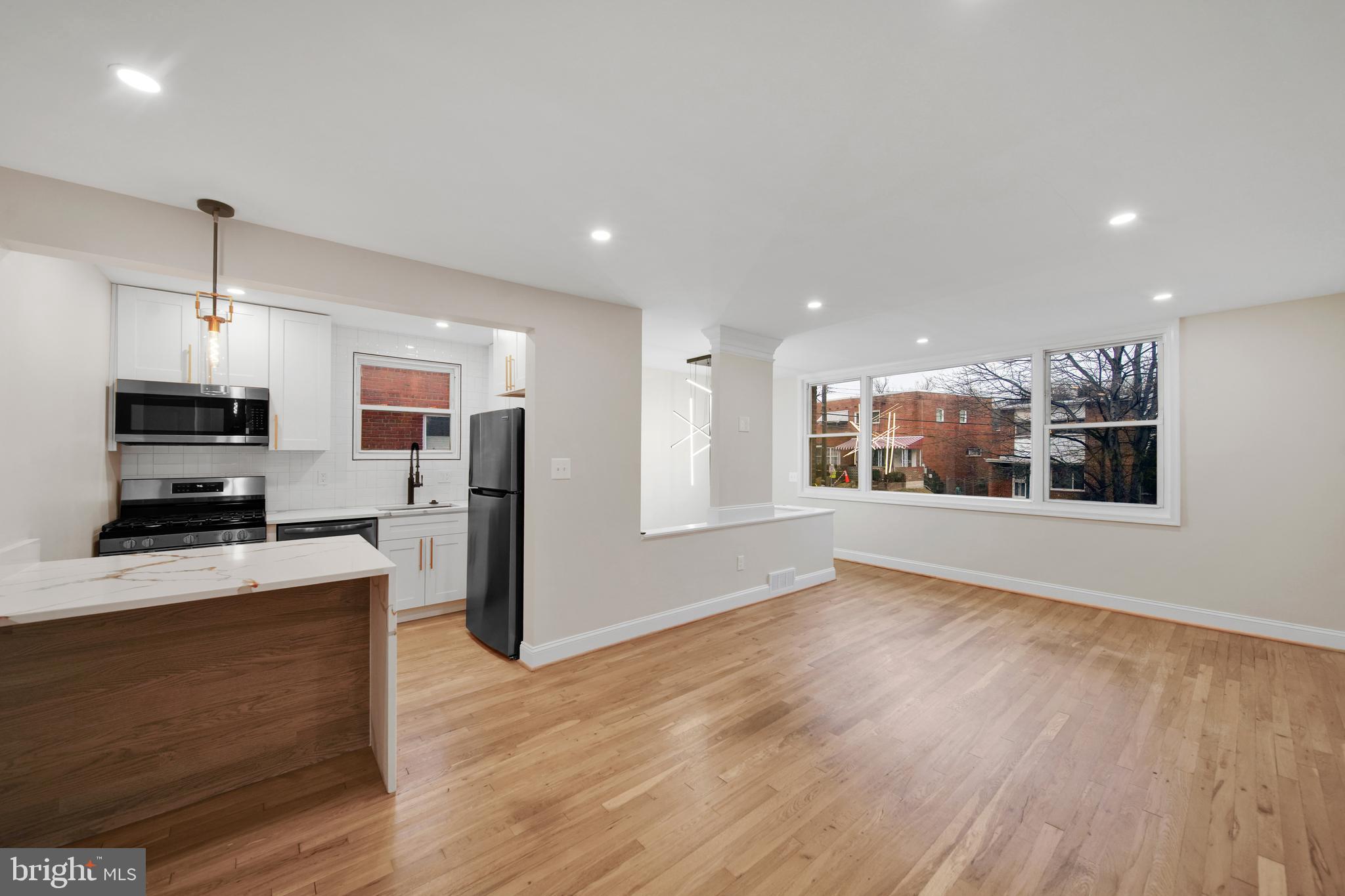 119 Victor Street Northeast, Unit 2 Washington, DC 20011 - Photo 5 of 25 a view of kitchen with stainless steel appliances refrigerator oven and microwave