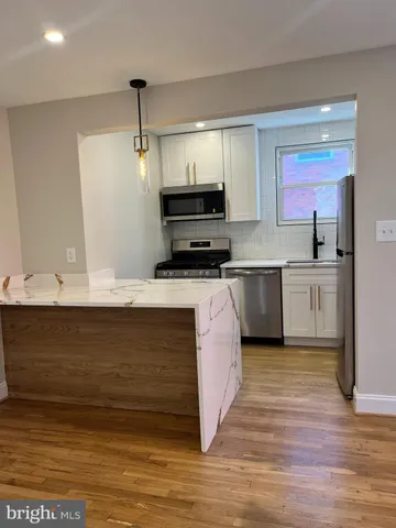 a kitchen with refrigerator and a sink
