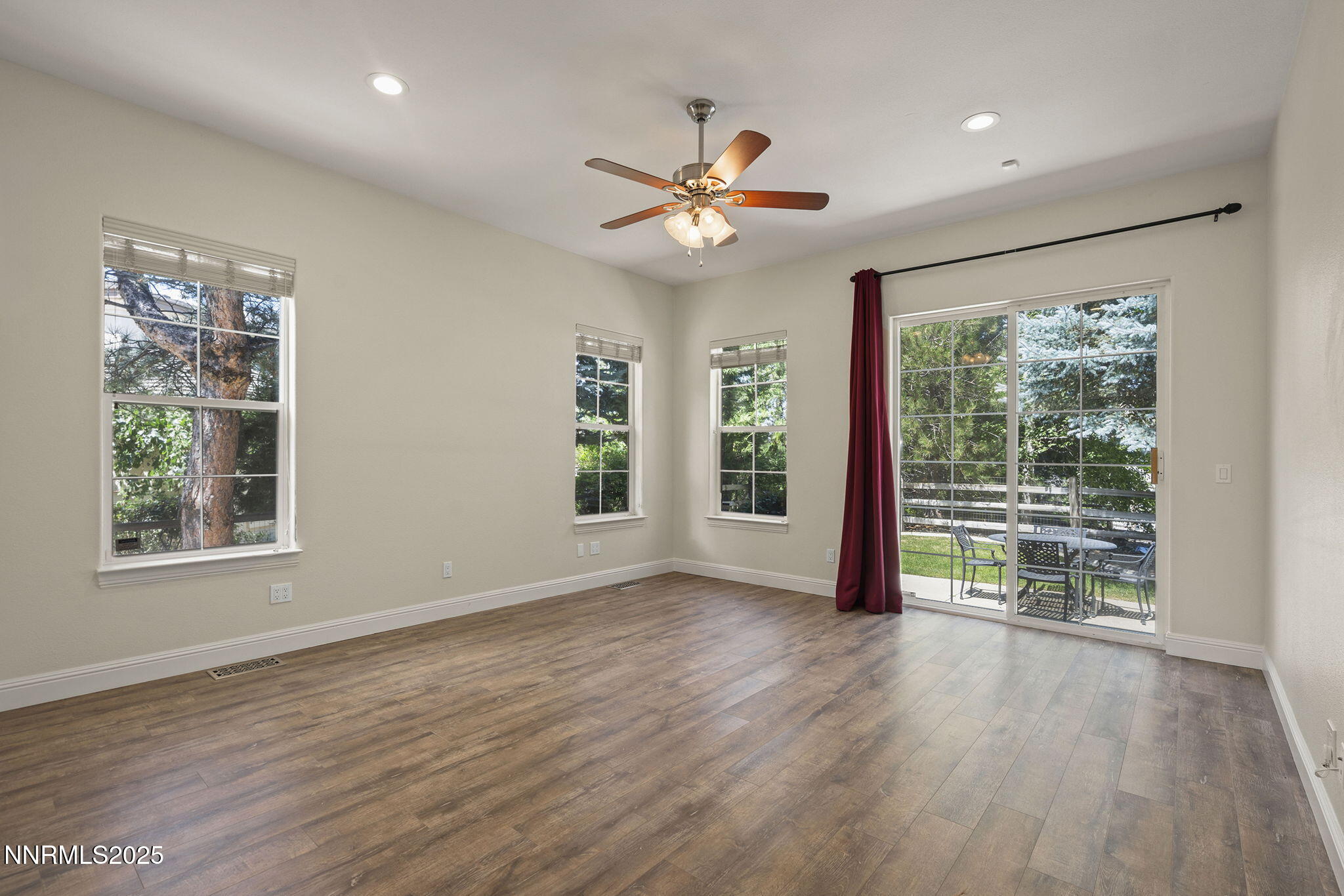4885 Buckhaven Road Reno, NV 89519 - Photo 22 of 54 a view of an empty room with wooden floor and a window