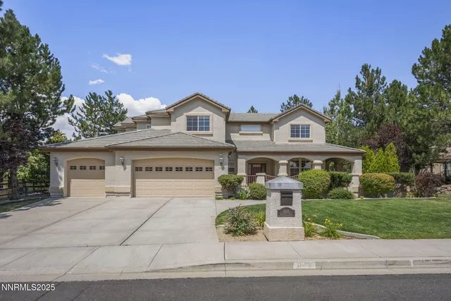 a front view of a house with a garden and plants