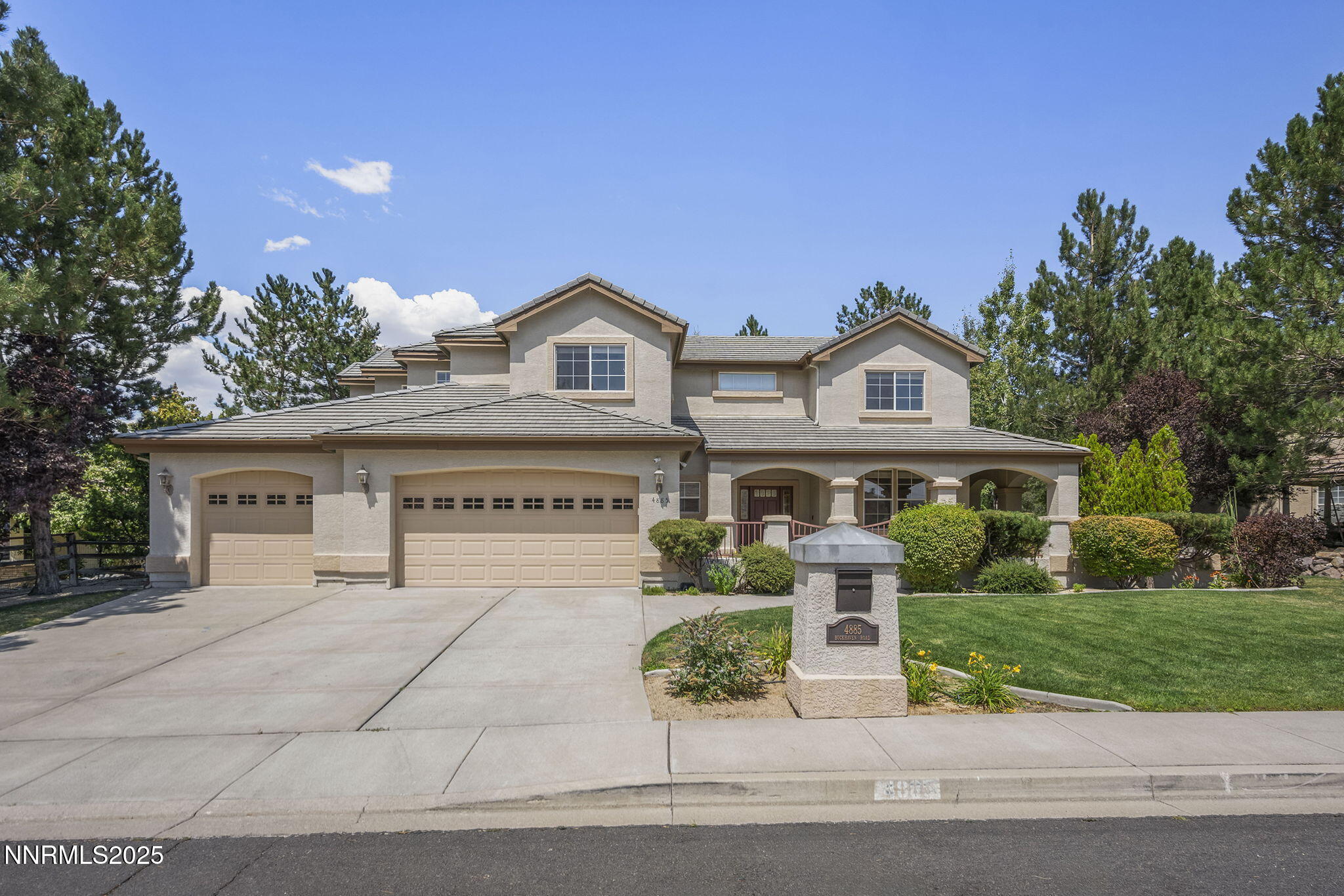 4885 Buckhaven Road Reno, NV 89519 - Photo 3 of 54 a front view of a house with a garden and plants