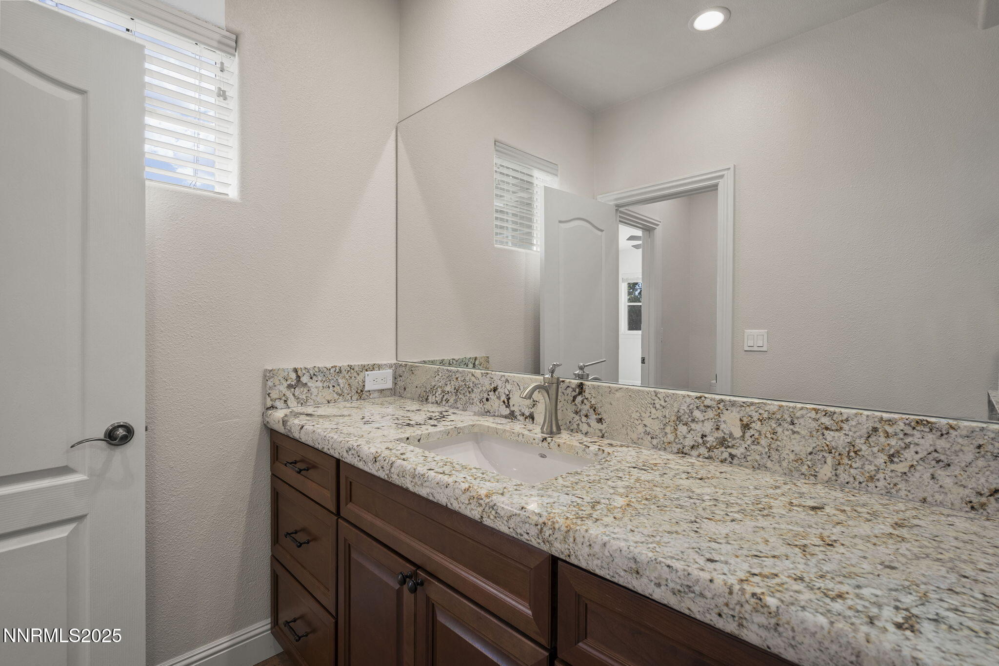 4885 Buckhaven Road Reno, NV 89519 - Photo 31 of 54 a bathroom with a granite countertop sink and a mirror