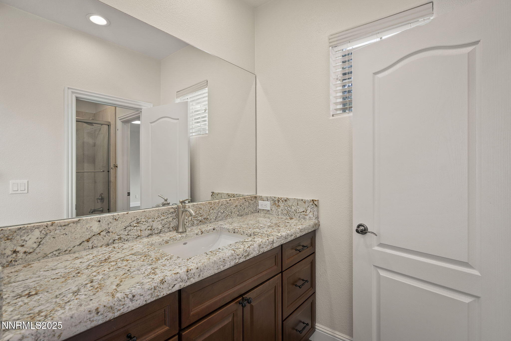 4885 Buckhaven Road Reno, NV 89519 - Photo 33 of 54 a bathroom with a granite countertop sink and a mirror