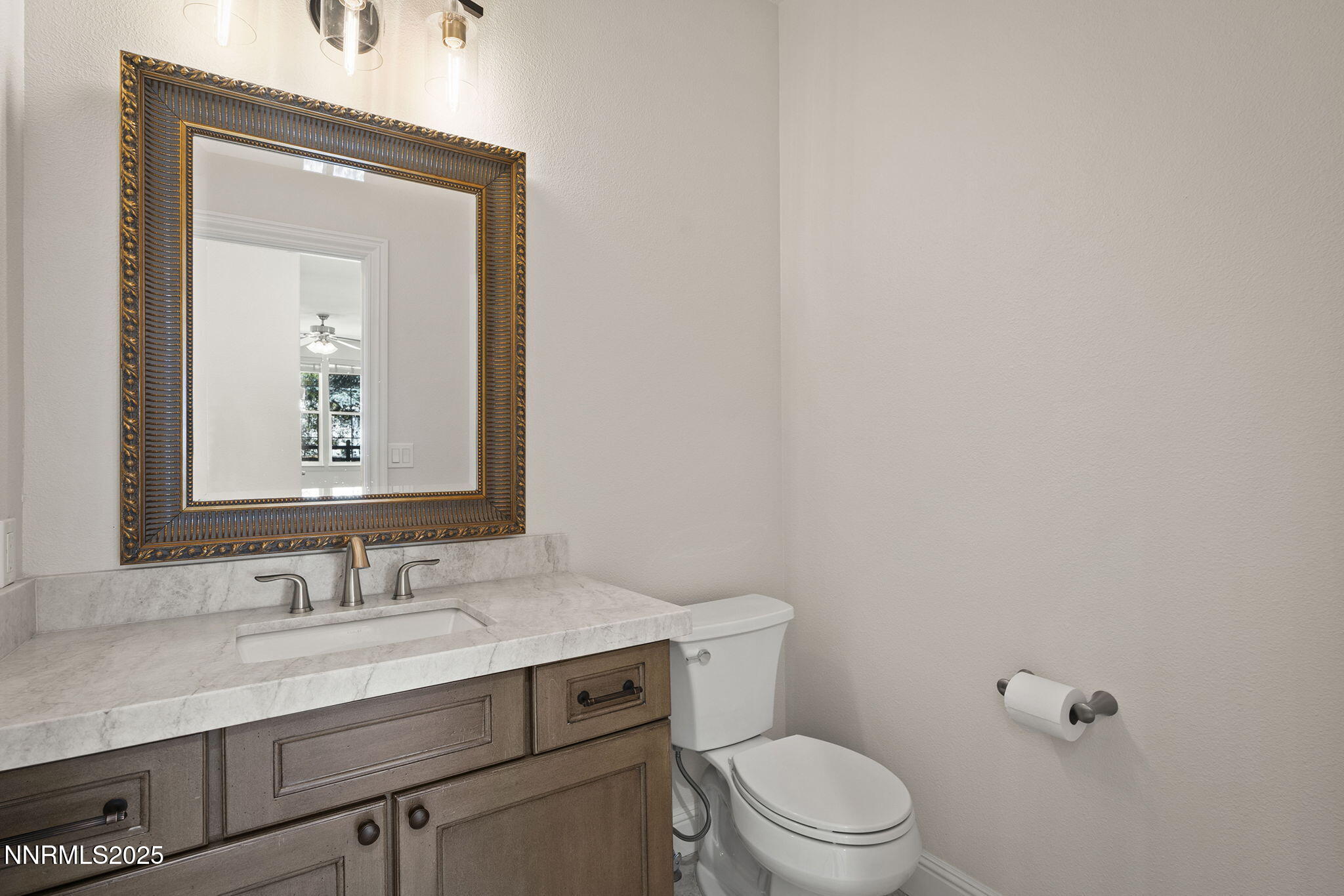 4885 Buckhaven Road Reno, NV 89519 - Photo 37 of 54 a bathroom with a granite countertop toilet a sink and mirror