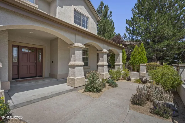 a front view of a house with a garden