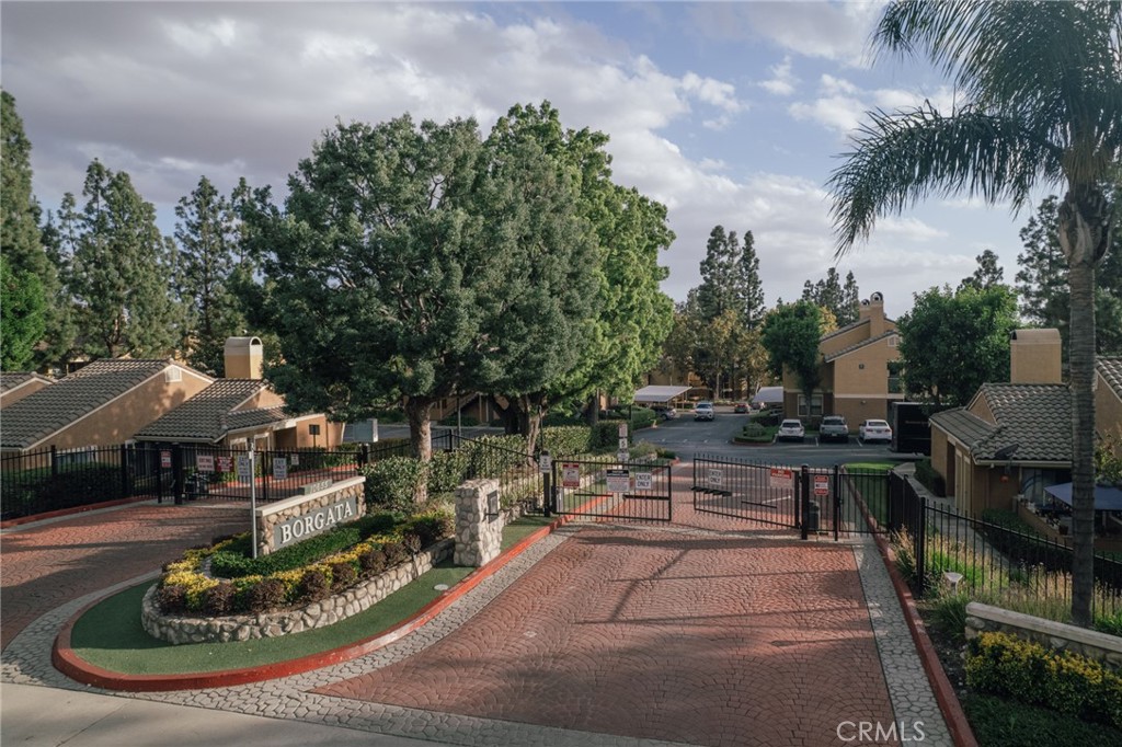 10655 Lemon Avenue, Unit 2703 Rancho Cucamonga, CA 91737 - Photo 2 of 31 a view of a patio with table and chairs potted plants and palm trees