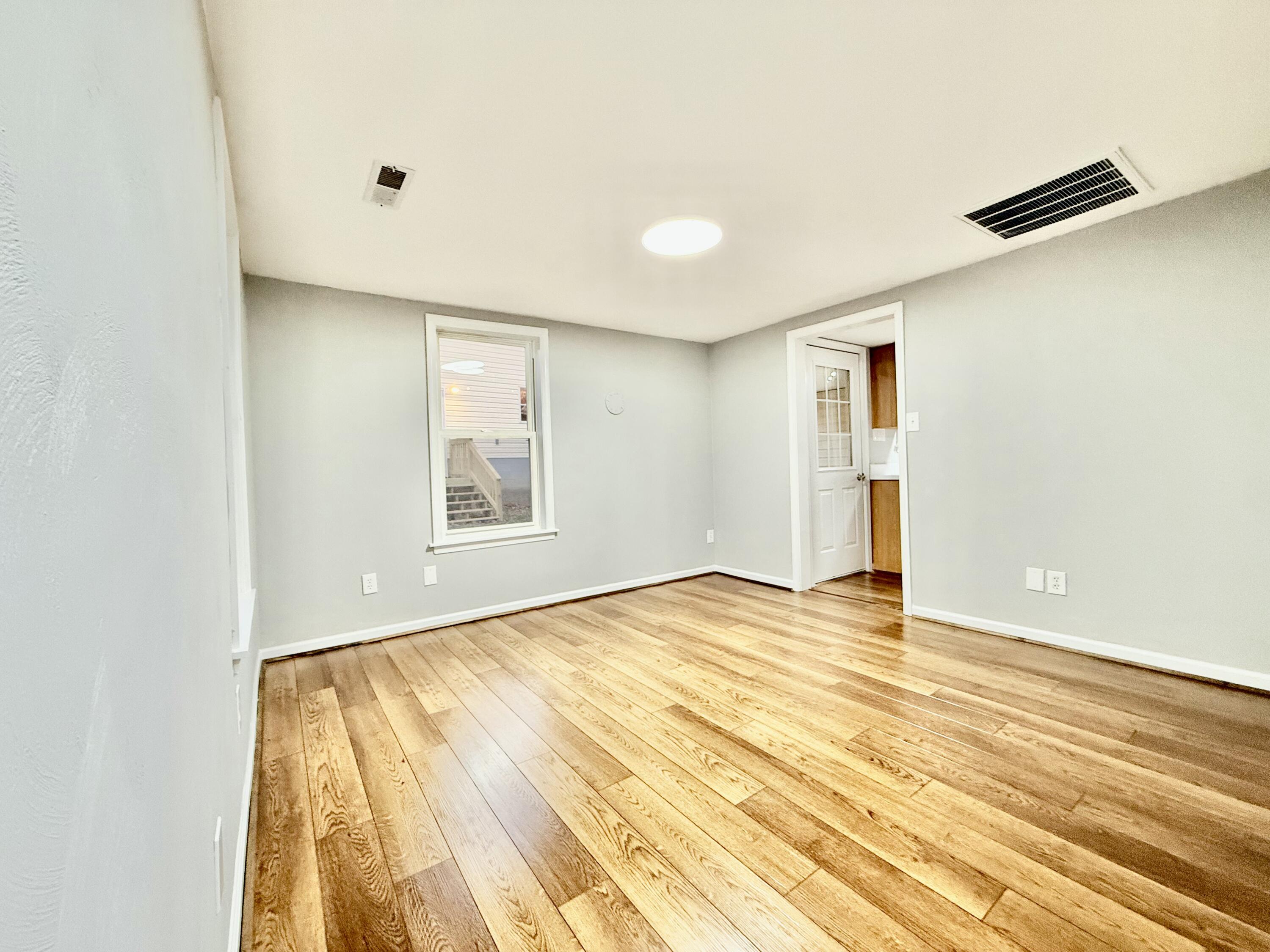 3715 Sandlewood Road Roanoke, VA 24018 - Photo 12 of 15 a view of an empty room with wooden floor and a window
