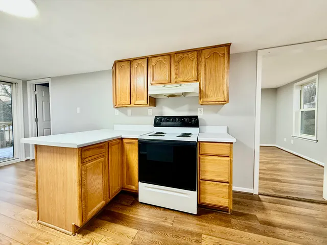 a kitchen with stainless steel appliances granite countertop a stove a sink and a microwave