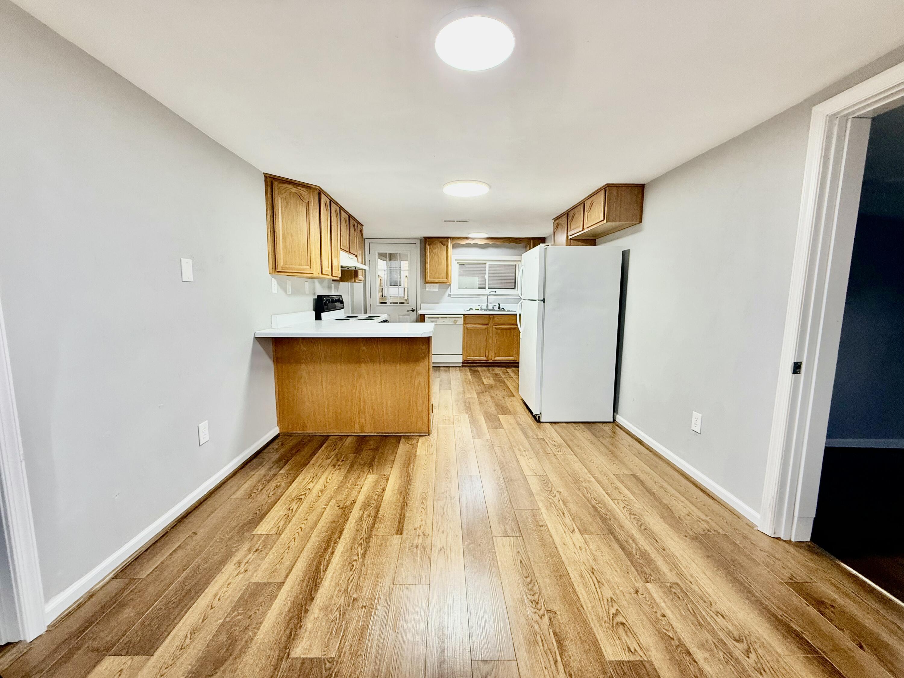 3715 Sandlewood Road Roanoke, VA 24018 - Photo 8 of 15 a view of a kitchen with wooden floor and a sink