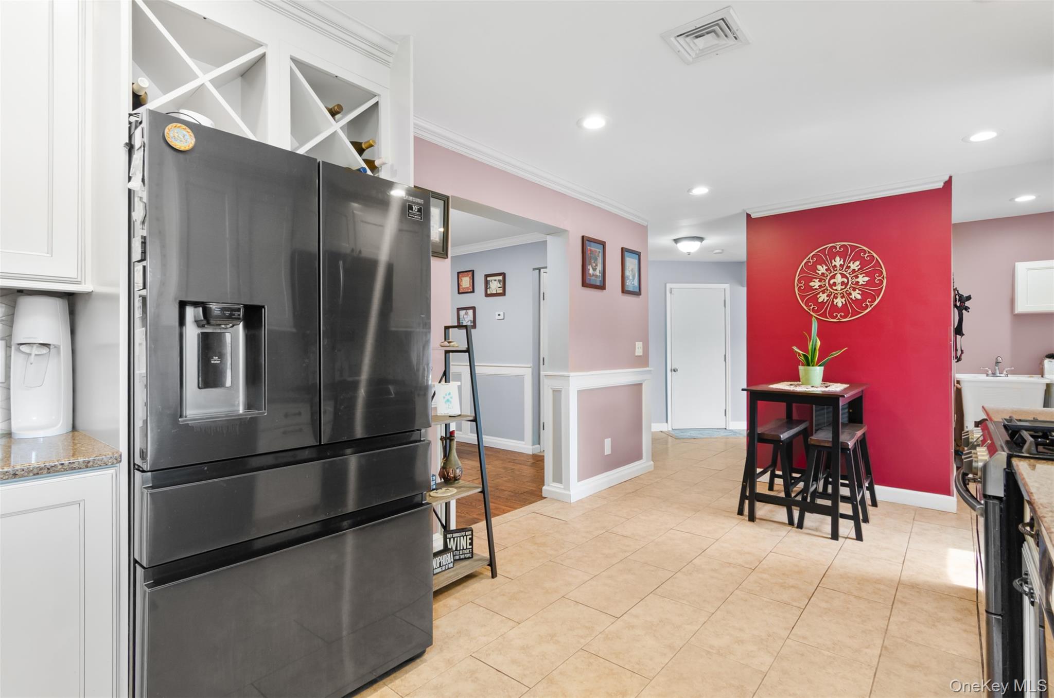 18 Calico Tree Lane Coram, NY 11727 - Photo 12 of 35 a kitchen with stainless steel appliances a refrigerator and wooden cabinets