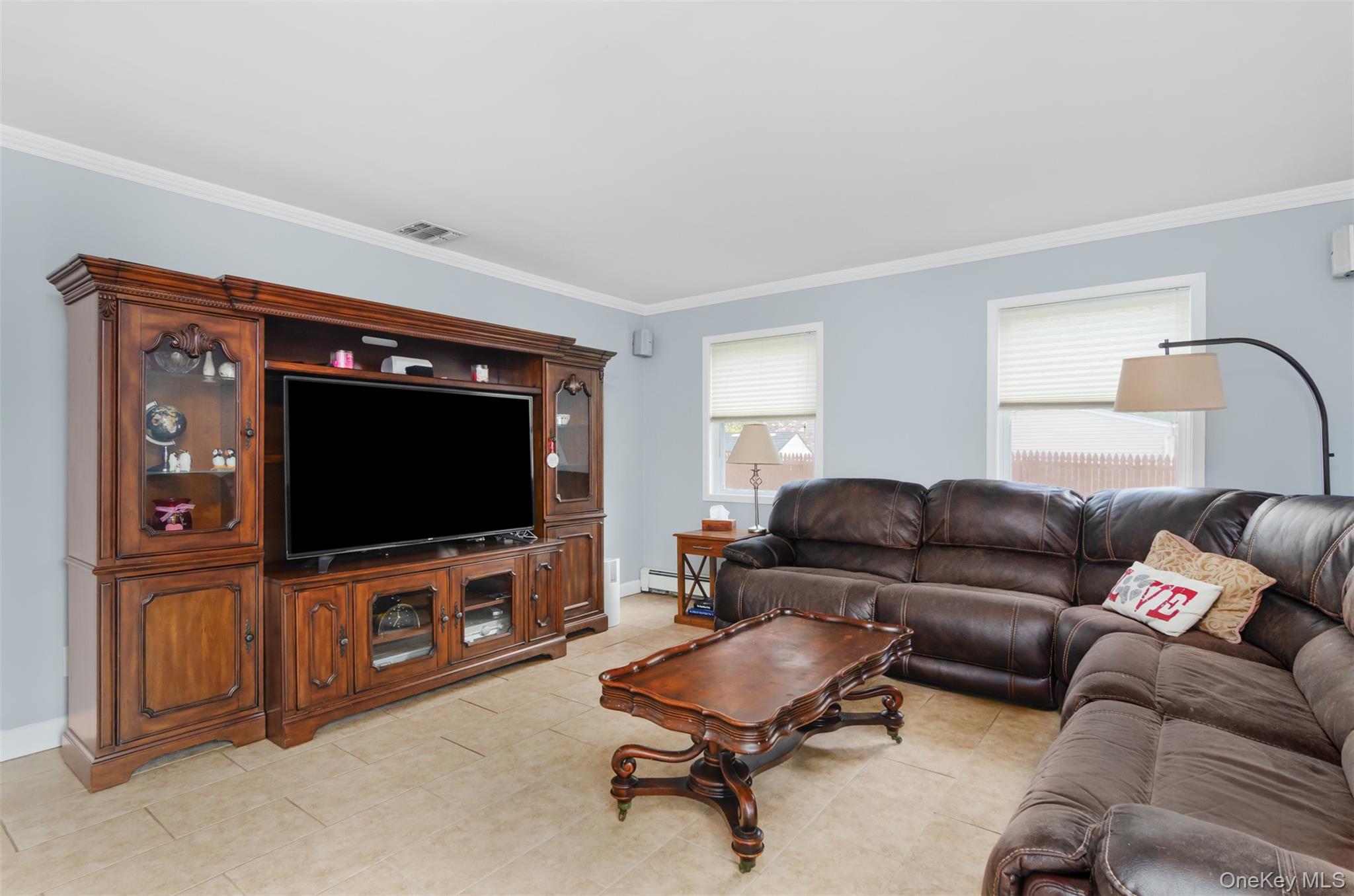 18 Calico Tree Lane Coram, NY 11727 - Photo 15 of 35 a living room with furniture and a flat screen tv