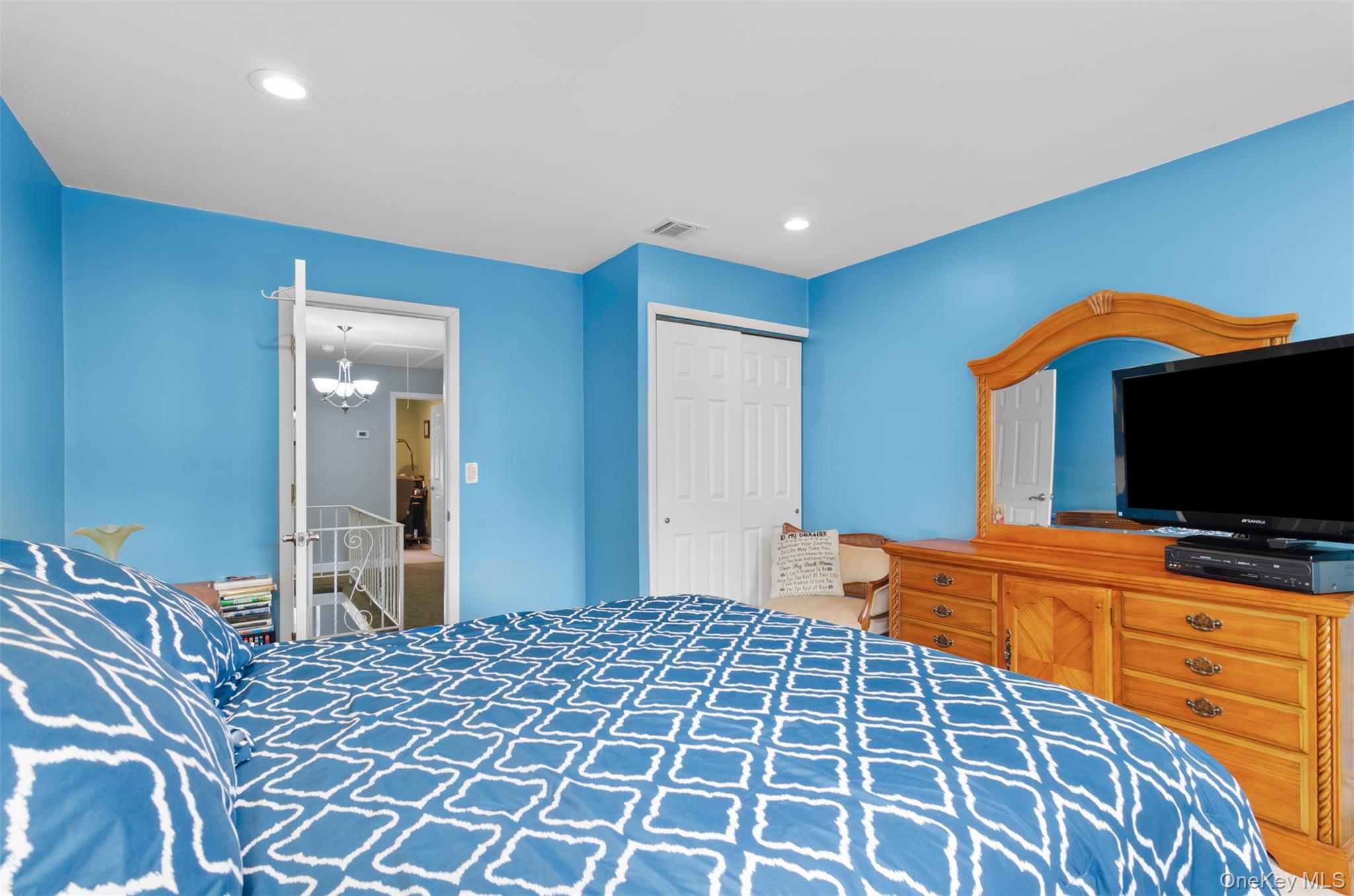 18 Calico Tree Lane Coram, NY 11727 - Photo 19 of 35 a bedroom with a bed and a flat screen tv