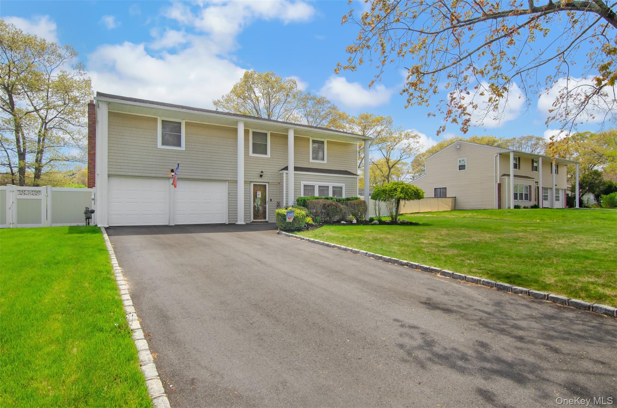 18 Calico Tree Lane Coram, NY 11727 - Photo 2 of 35 a front view of house with yard and green space