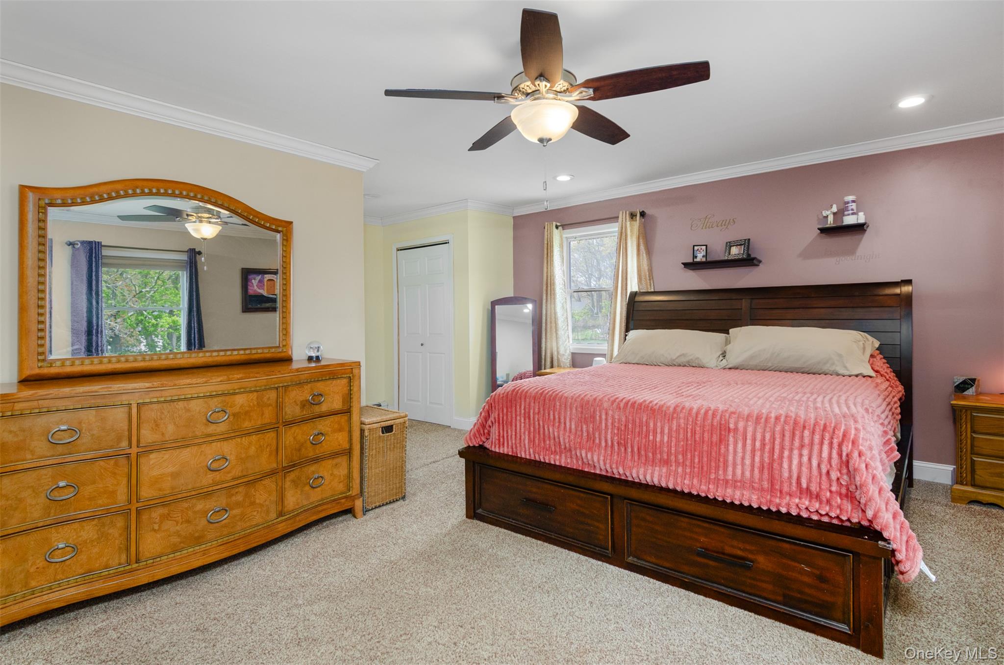 18 Calico Tree Lane Coram, NY 11727 - Photo 21 of 35 a spacious bedroom with a bed a chandelier and a mirror on dresser