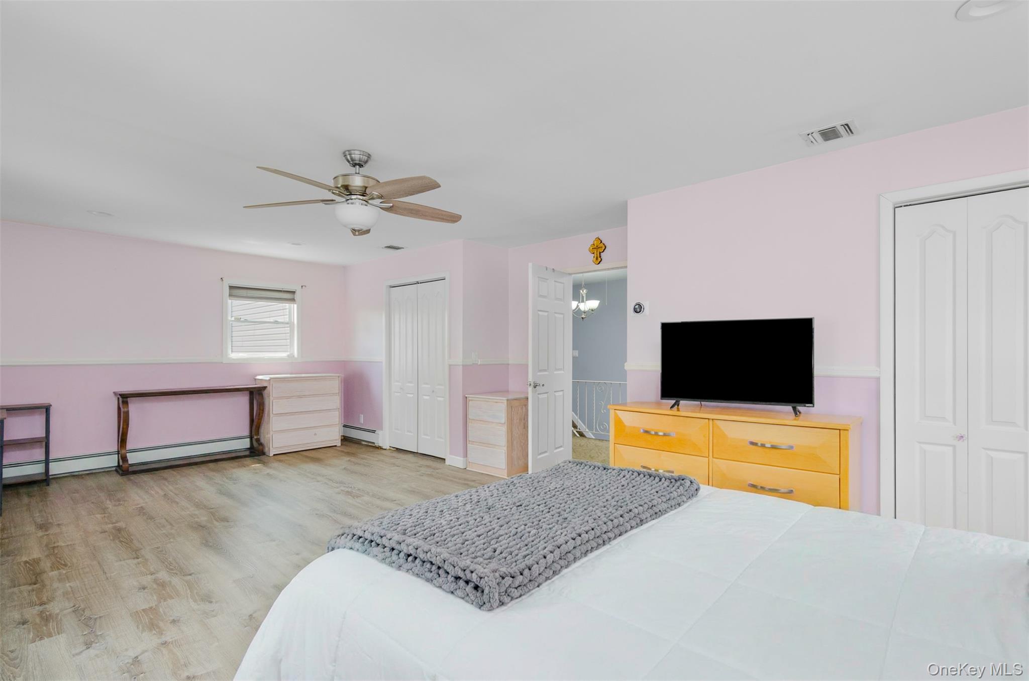 18 Calico Tree Lane Coram, NY 11727 - Photo 26 of 35 a bedroom with a bed and a flat screen tv