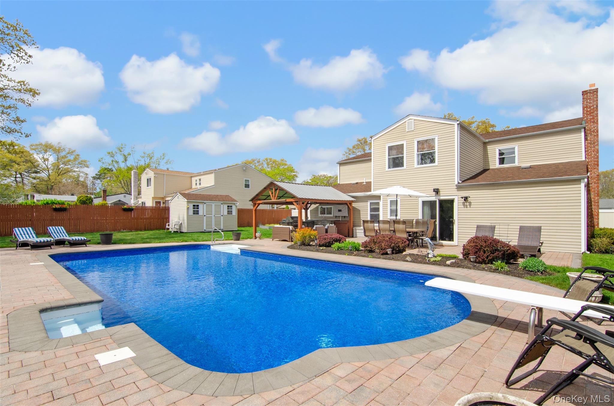 18 Calico Tree Lane Coram, NY 11727 - Photo 31 of 35 a view of a swimming pool and lounge chairs