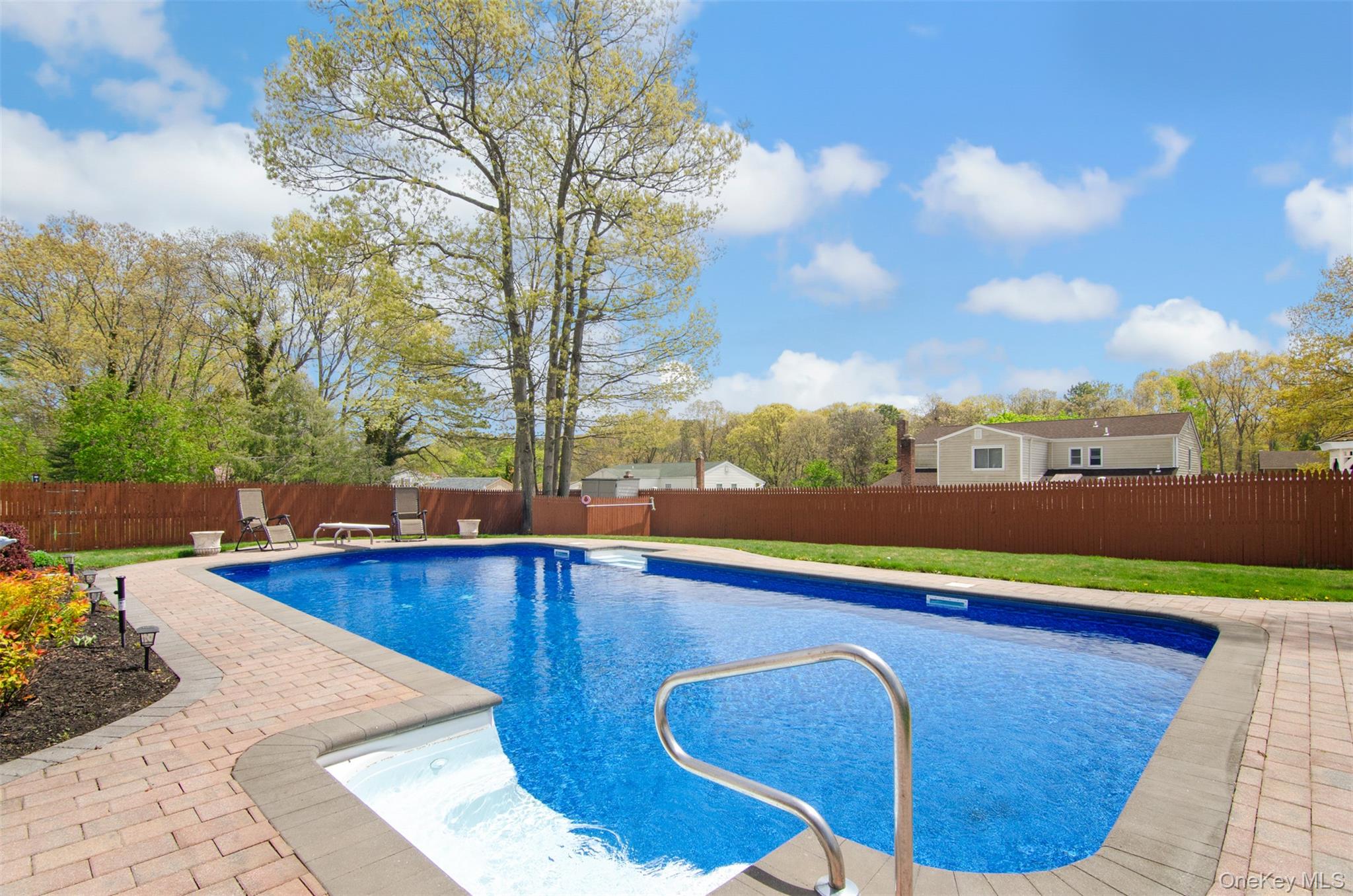 18 Calico Tree Lane Coram, NY 11727 - Photo 32 of 35 a view of a swimming pool with a lounge chair