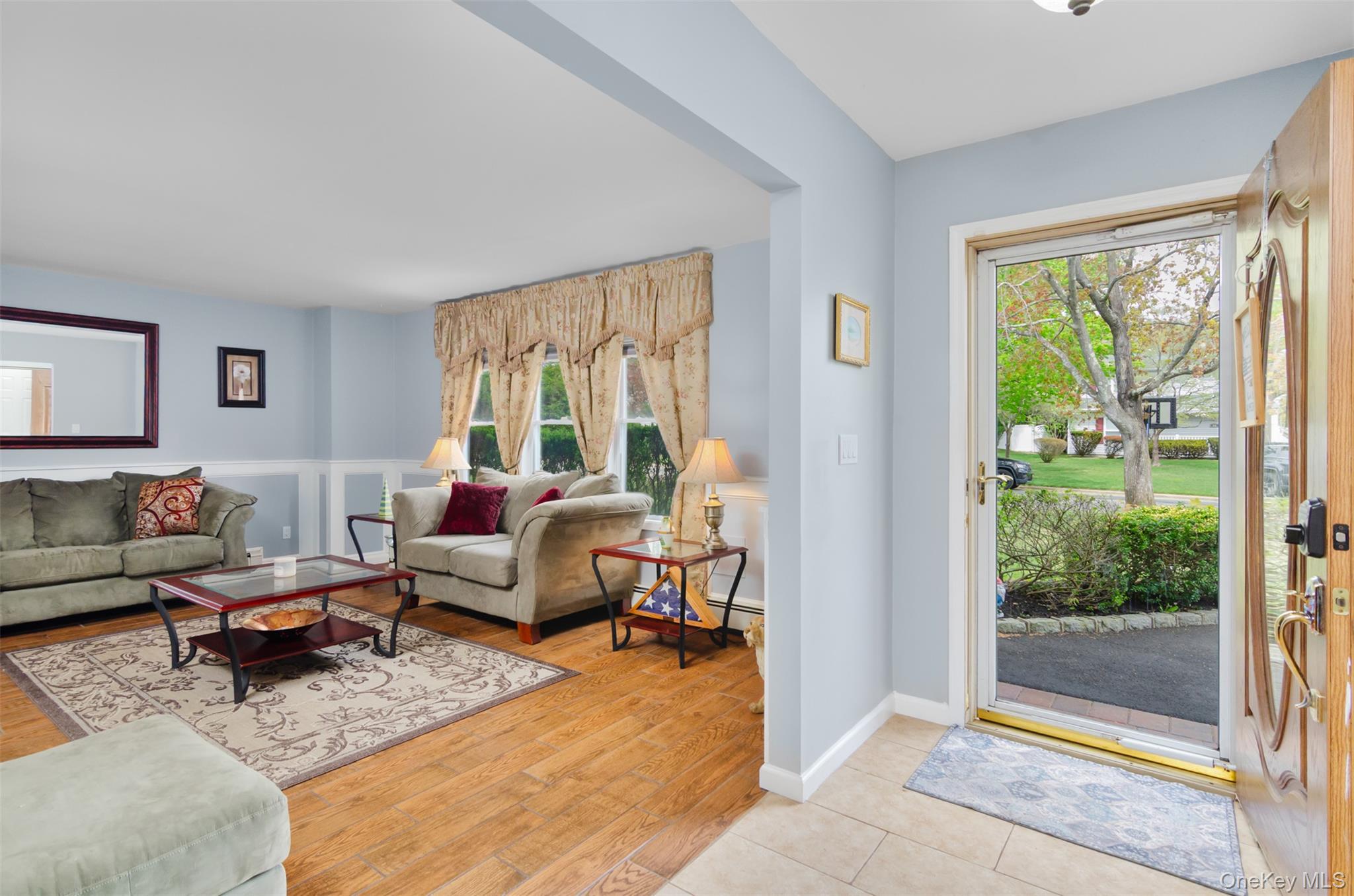 18 Calico Tree Lane Coram, NY 11727 - Photo 4 of 35 a living room with furniture and a large window