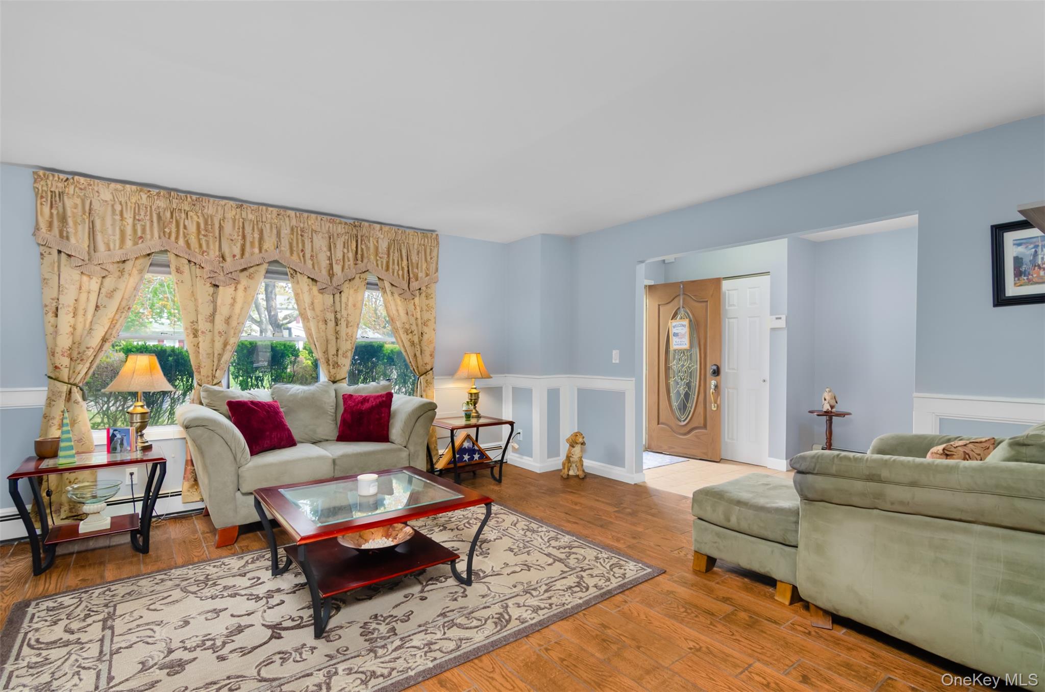 18 Calico Tree Lane Coram, NY 11727 - Photo 6 of 35 a living room with furniture a rug and a large window