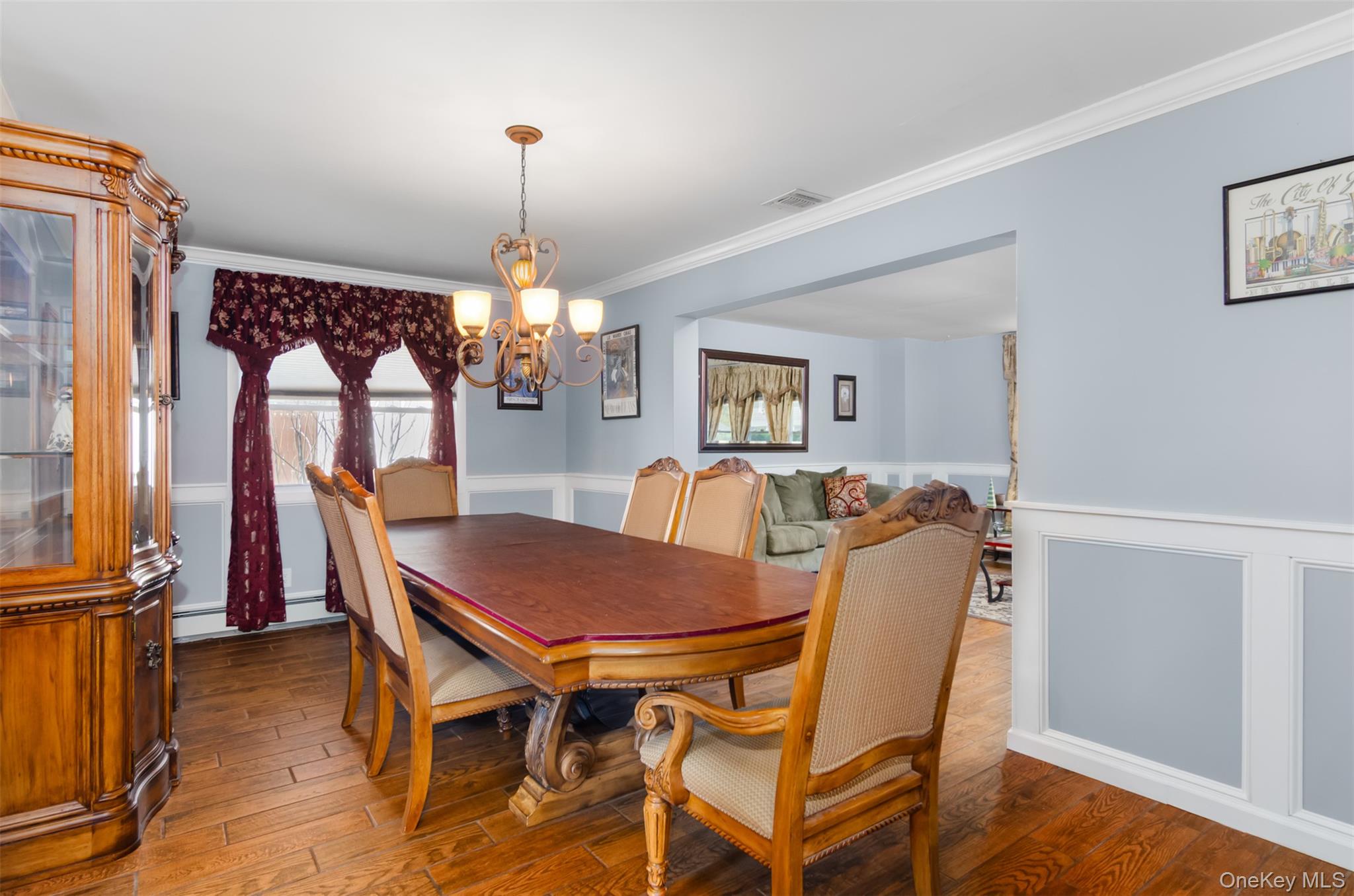 18 Calico Tree Lane Coram, NY 11727 - Photo 7 of 35 a dining room with furniture a chandelier and wooden floor