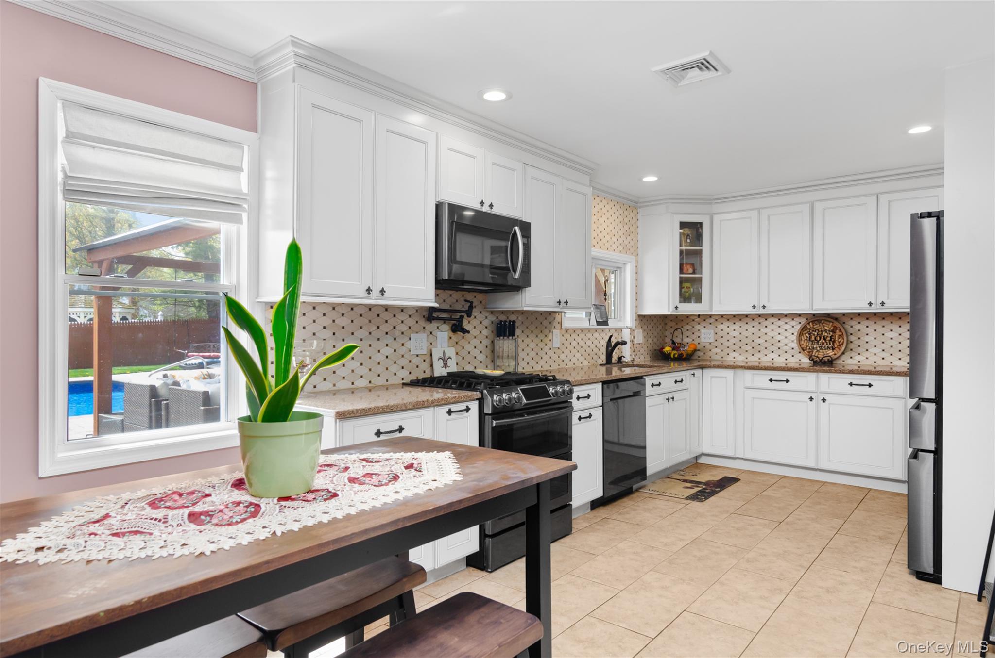 18 Calico Tree Lane Coram, NY 11727 - Photo 10 of 35 a kitchen with a refrigerator and a white cabinets