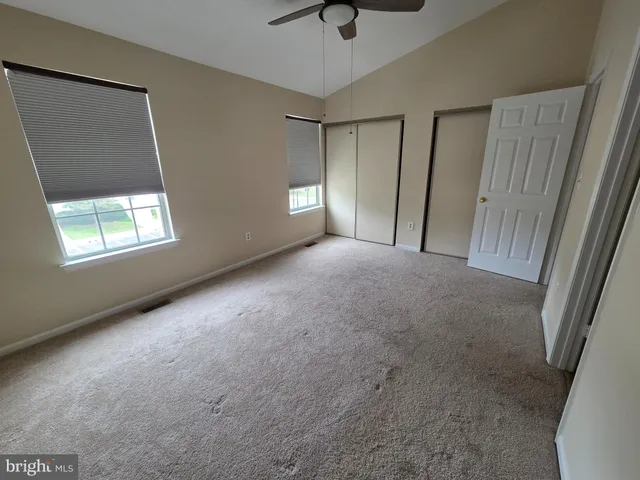 a view of a livingroom with a window and a ceiling fan
