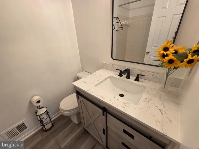 a bathroom with a sink mirror and toilet