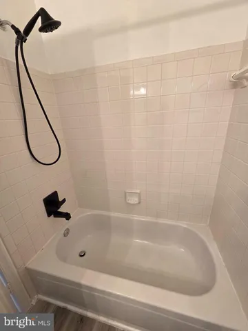 a bathroom with a bath tub and a shower