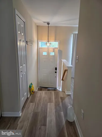 a view of an entryway with wooden floor