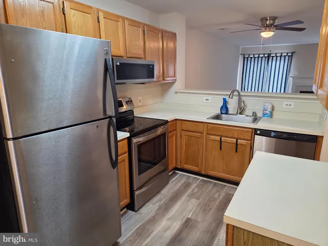 a kitchen with stainless steel appliances a refrigerator sink and cabinets
