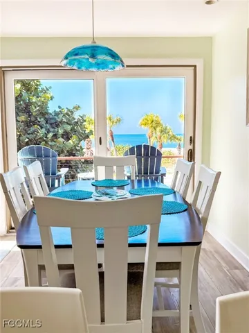 a dining room with furniture a chandelier and wooden floor