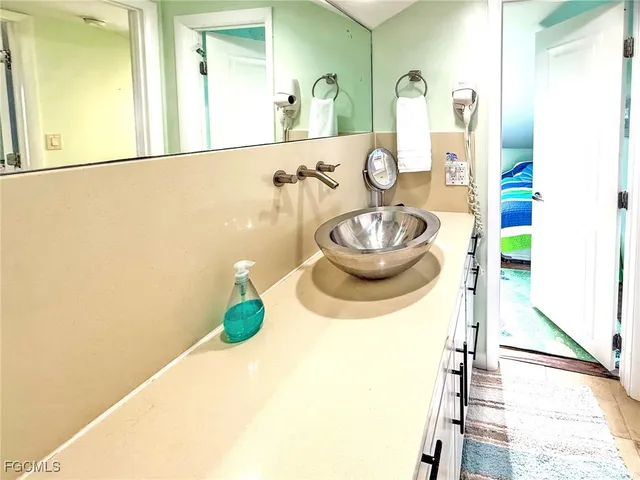 a bathroom with a tub sink and mirror