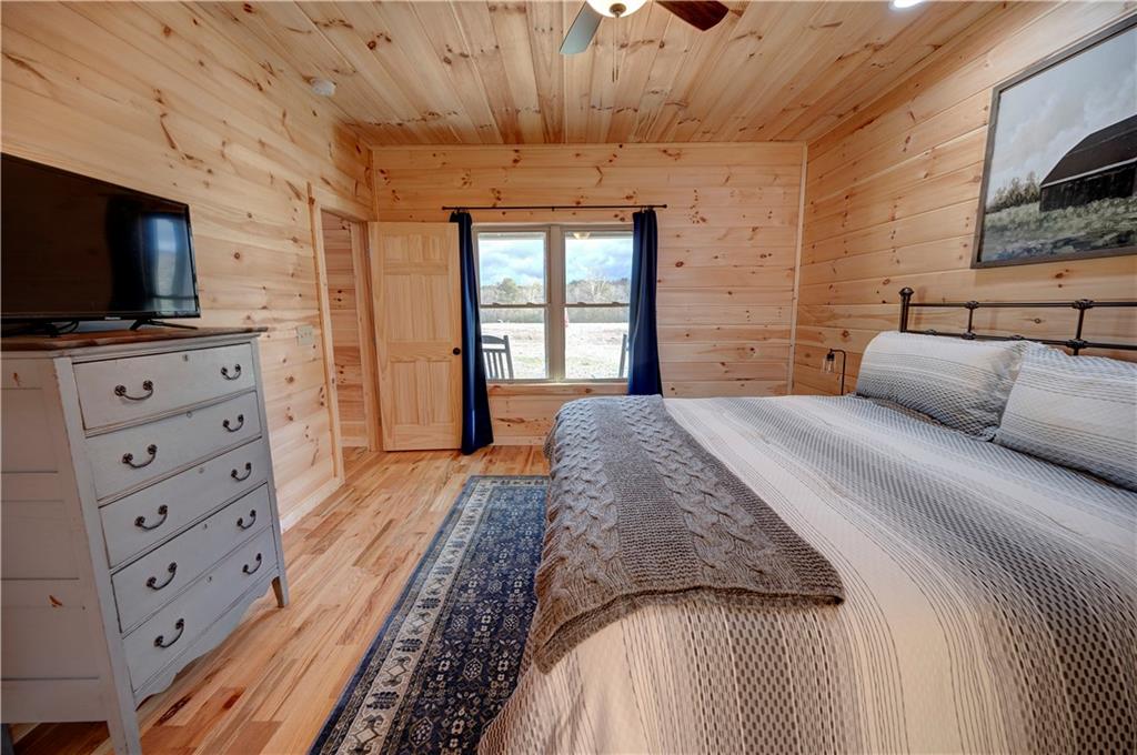 2092 Pleasant Hill Road Northeast Ranger, GA 30734 - Photo 21 of 88 a spacious bedroom with a bed and a flat screen tv