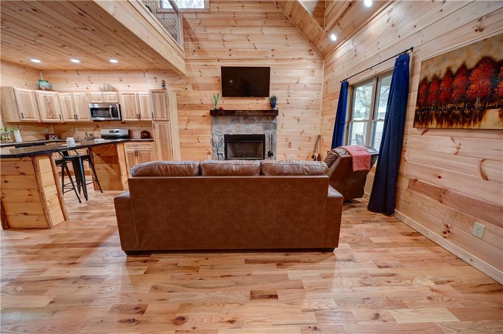 2092 Pleasant Hill Road Northeast Ranger, GA 30734 - Photo 4 of 87 a living room with furniture a flat screen tv and a fireplace