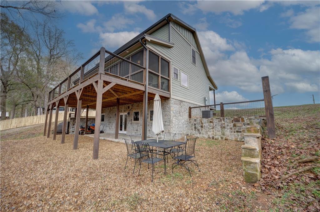 2092 Pleasant Hill Road Northeast Ranger, GA 30734 - Photo 56 of 87 a wooden bench sitting in front of a house