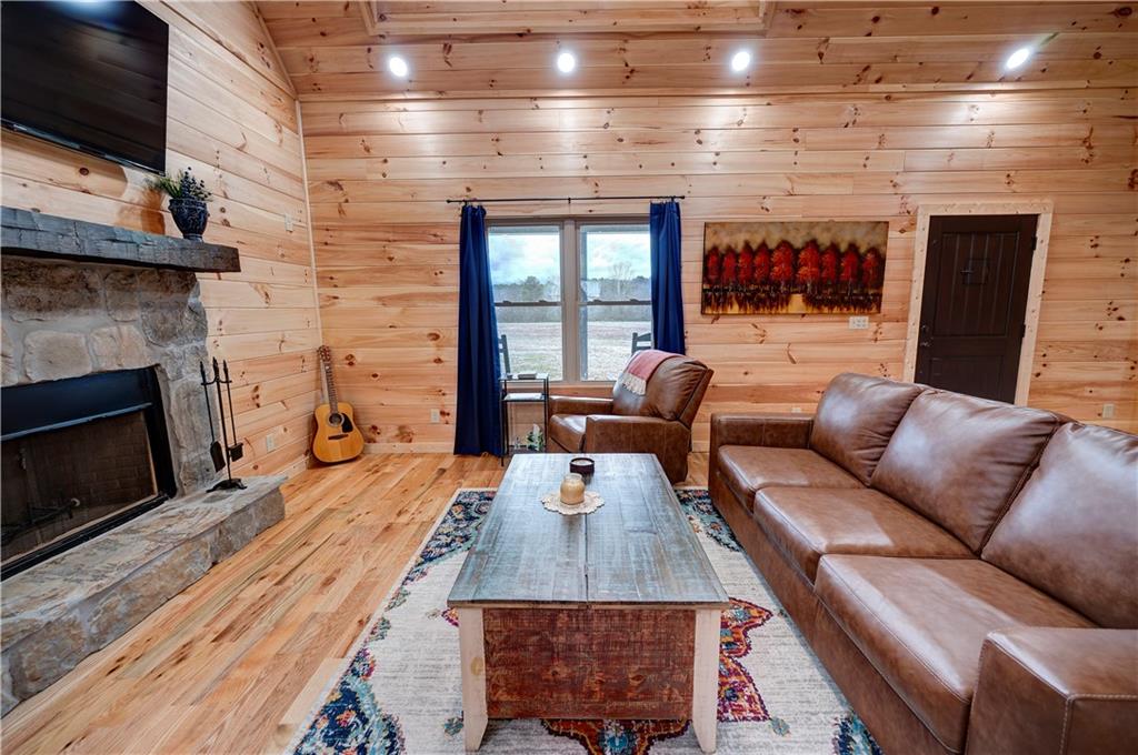 2092 Pleasant Hill Road Northeast Ranger, GA 30734 - Photo 6 of 87 a living room with furniture a flat screen tv and a fireplace